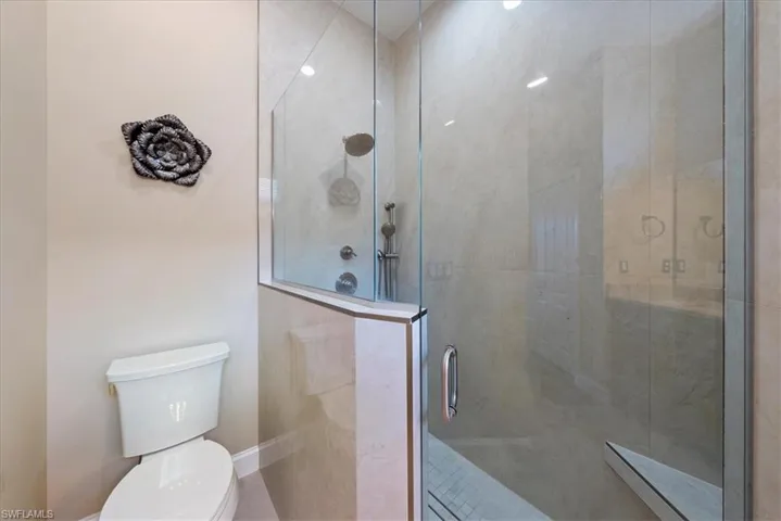 Bathroom with an enclosed shower and toilet