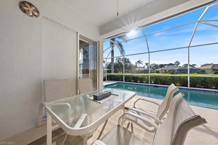 View of pool with glass enclosure