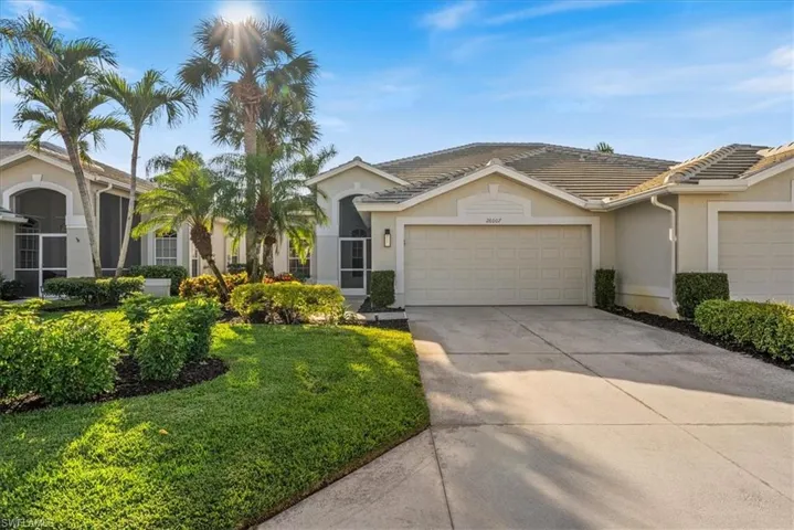 Single story home with a garage and a front yard