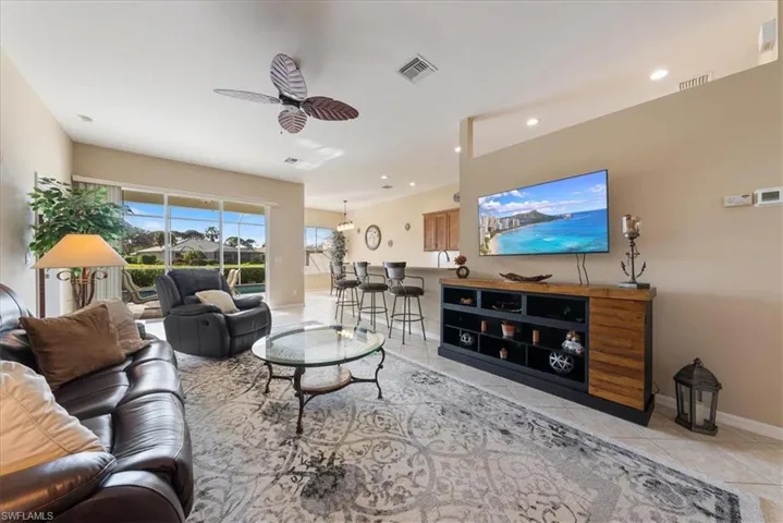 Living room featuring ceiling fan and light tile patterned floors