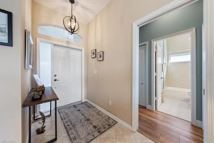 Foyer entrance featuring a chandelier and light tile patterned floors