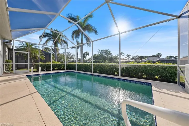 View of swimming pool featuring a lanai and a patio area
