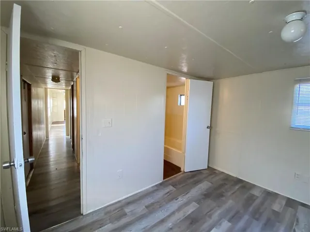 Empty room with dark wood finished floors