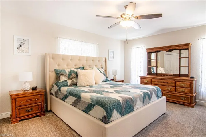 Carpeted bedroom with ceiling fan