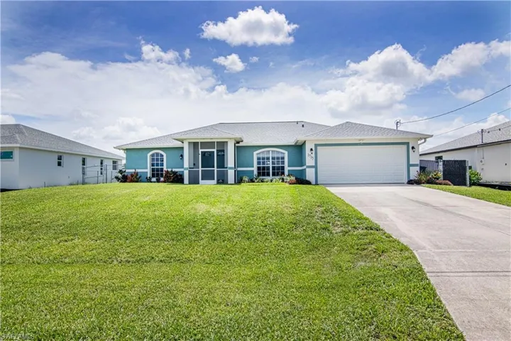 Single story home with a front yard and a garage