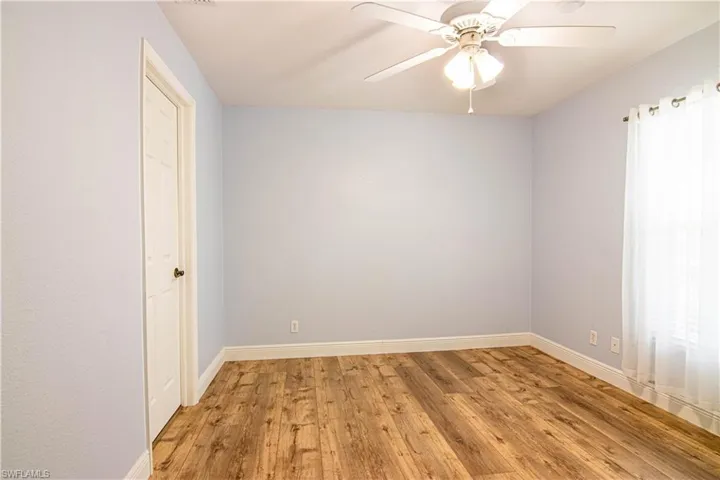 Empty room featuring hardwood / wood-style floors and ceiling fan