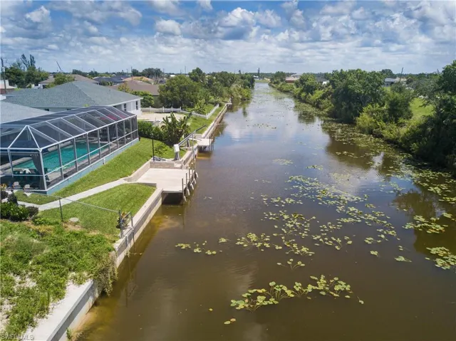 Property view of water with a dock