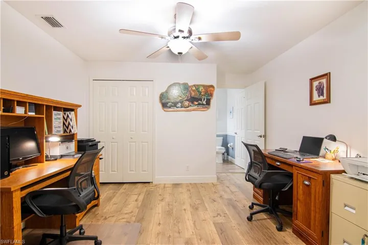 Home office featuring ceiling fan and light wood-type flooring