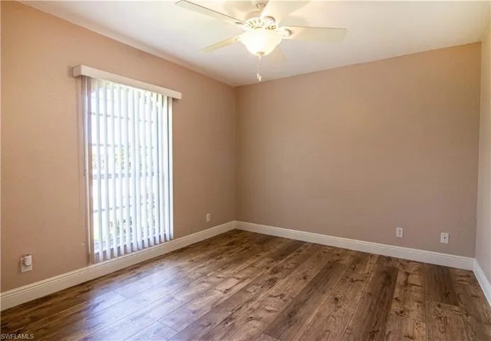 Spare room featuring wood-type flooring and ceiling fan