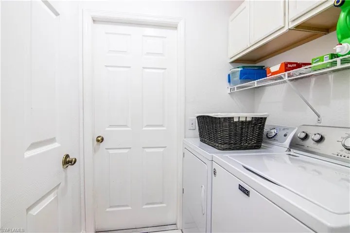 Washroom featuring washer and dryer and cabinets