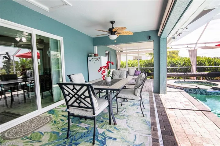 View of patio / terrace featuring ceiling fan, a pool with hot tub, and an outdoor hangout area