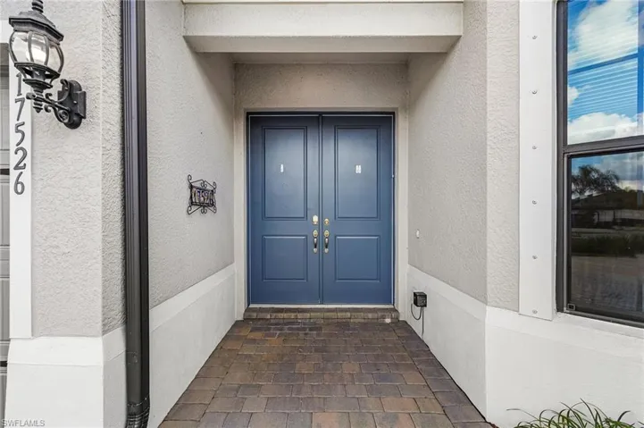 Property entrance featuring stucco siding