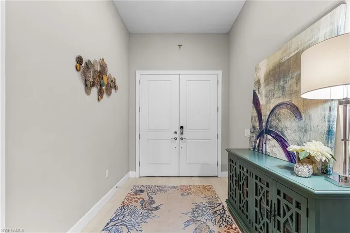 Entryway with baseboards and wood finished floors