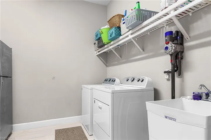 Laundry area featuring baseboards and separate washer and dryer