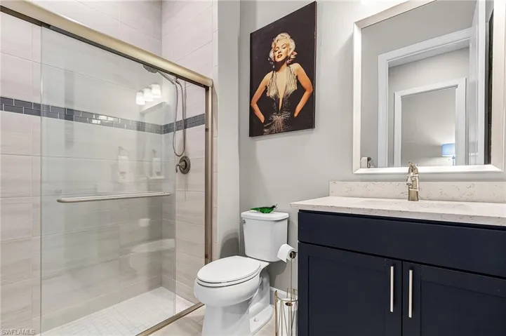 Bathroom with vanity and a stall shower