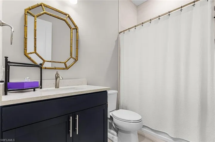 Full bathroom with toilet and vanity