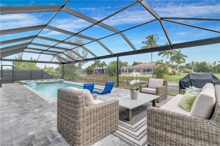 Outdoor pool featuring a patio, a lanai, an outdoor hangout area, and a fenced backyard