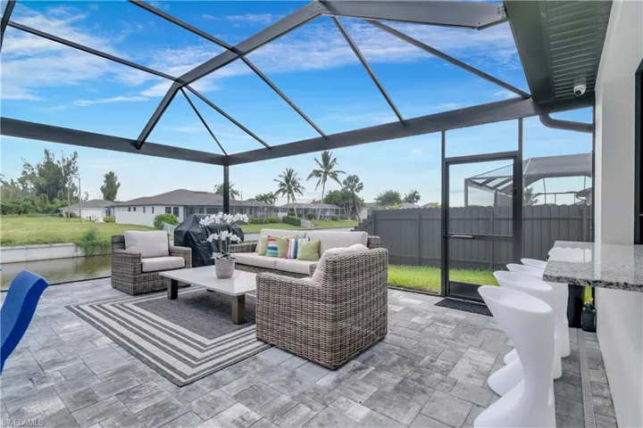 View of patio with glass enclosure, fence, and outdoor lounge area