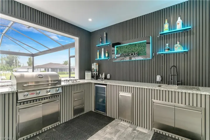 Bar with a sink, wet bar, and wine cooler
