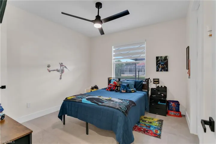 Bedroom with a ceiling fan and baseboards