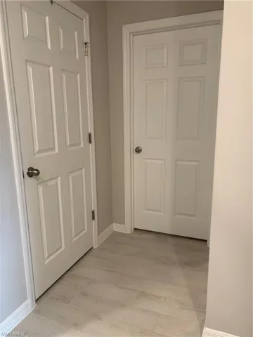 Bedroom door on the left and bathroom door on the right