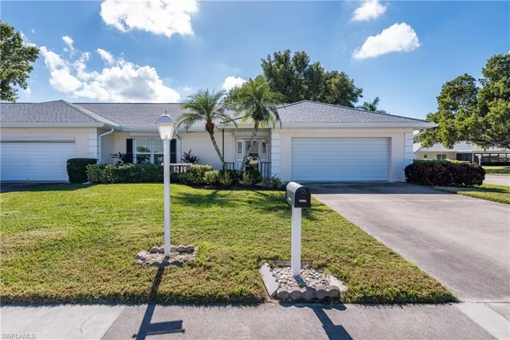 Single story home featuring a front yard, an attached garage, concrete driveway, and roof with shingles
