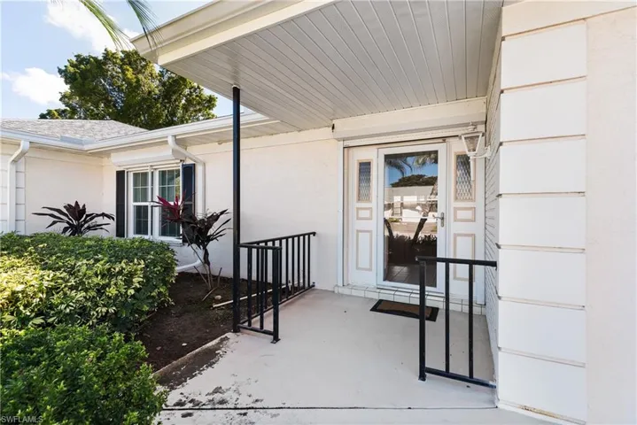 Entrance to property with stucco siding