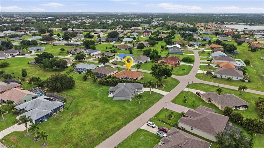 Aerial perspective showcasing a residential neighborhood with single-story homes and ample green spaces