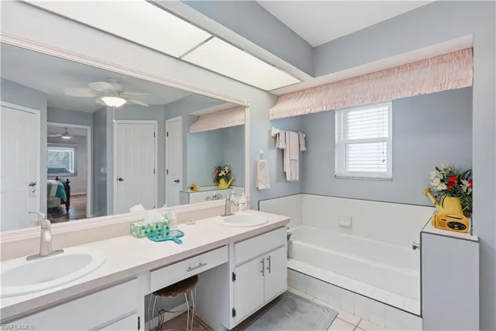 Dual vanity with undermount sinks and brushed nickel faucets set in a light countertop