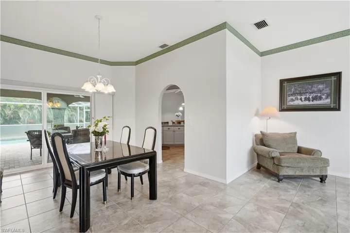 Spacious interior with tile flooring and a decorative green accent band