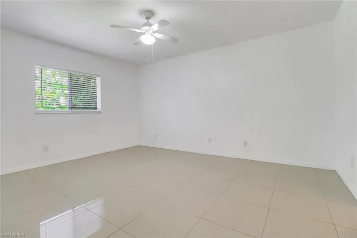 Spare room featuring light tile patterned floors and a ceiling fan
