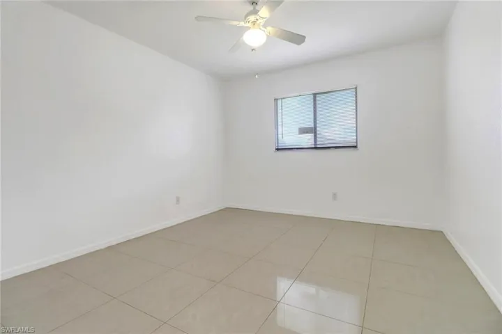 Spare room featuring light tile patterned floors and a ceiling fan