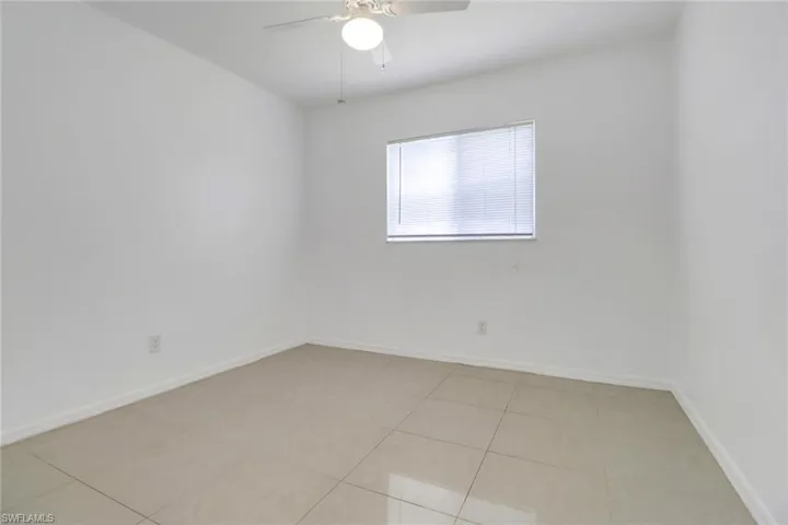Spare room featuring ceiling fan and light tile patterned flooring