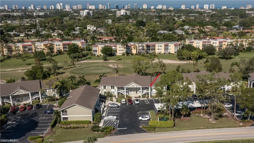 View of urban area with a golf club and apartment complex / building