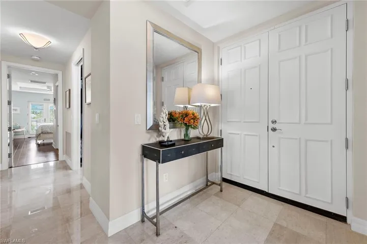 Hallway with light tile patterned floors