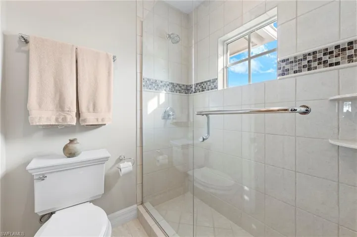 Bathroom featuring walk in shower and toilet