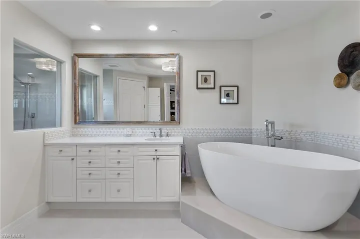 Bathroom with vanity, tile patterned flooring, and separate shower and tub