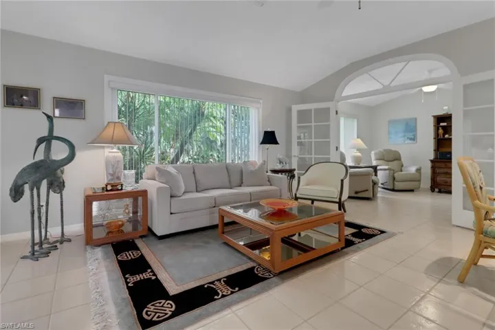 Tiled living room with lofted ceiling
