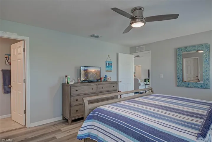 Bedroom with light wood finished floors and ceiling fan