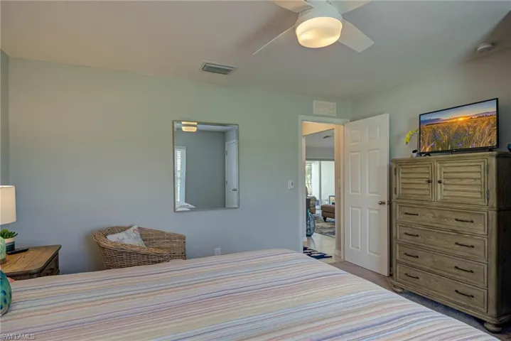 Bedroom featuring ceiling fan and carpet