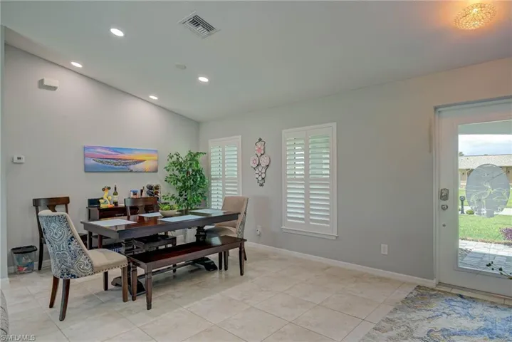 Dining space with recessed lighting, light tile patterned flooring, and vaulted ceiling