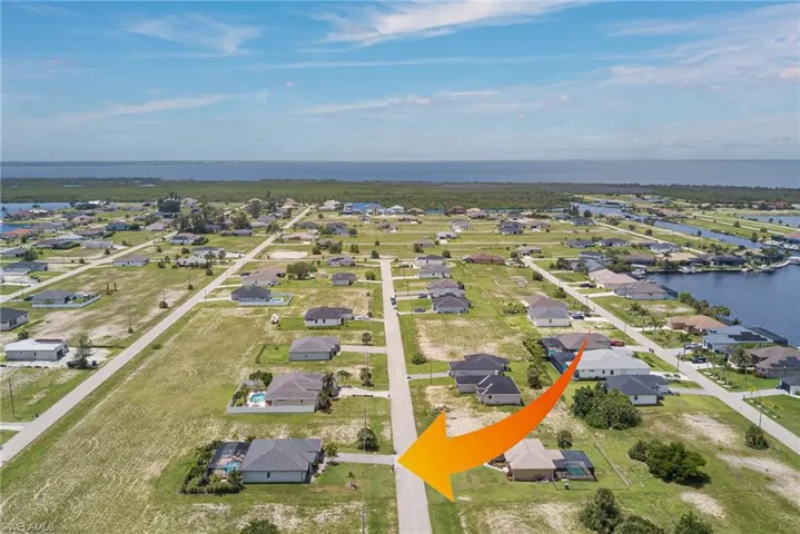 Aerial perspective of suburban area with a nearby body of water