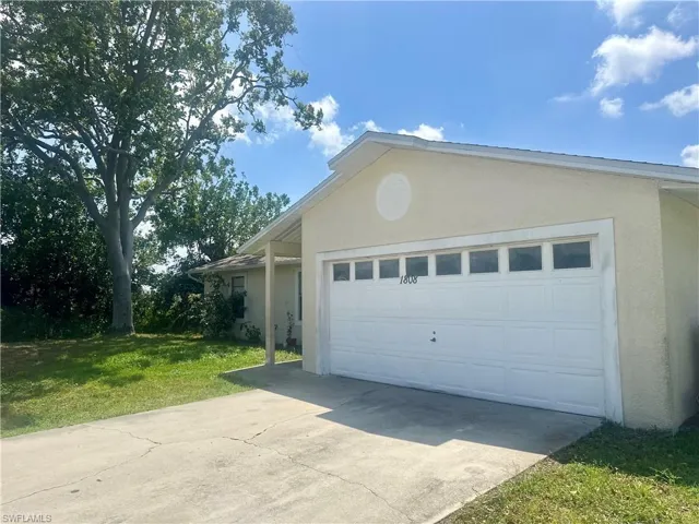 Garage featuring concrete driveway