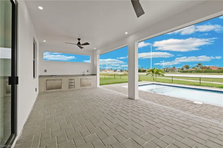 View of patio featuring an outdoor kitchen and ceiling fan