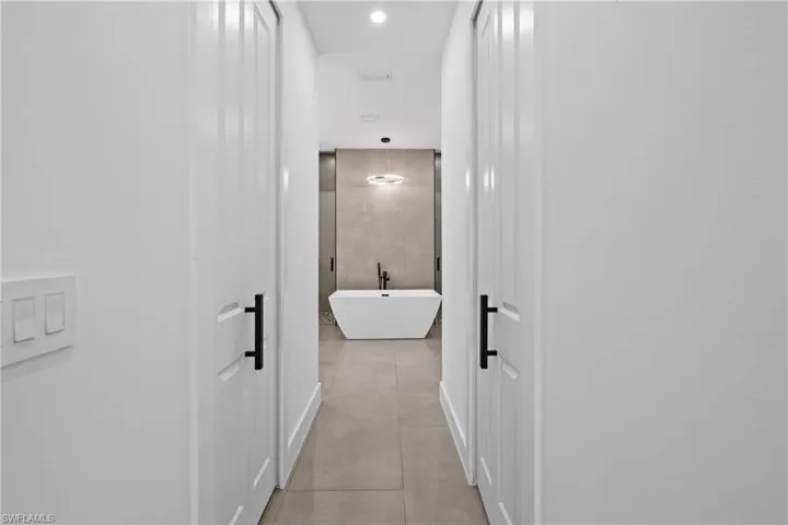 Corridor with light tile floors