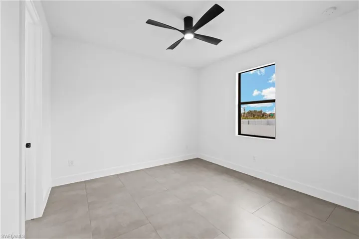 Spare room featuring tile flooring and ceiling fan