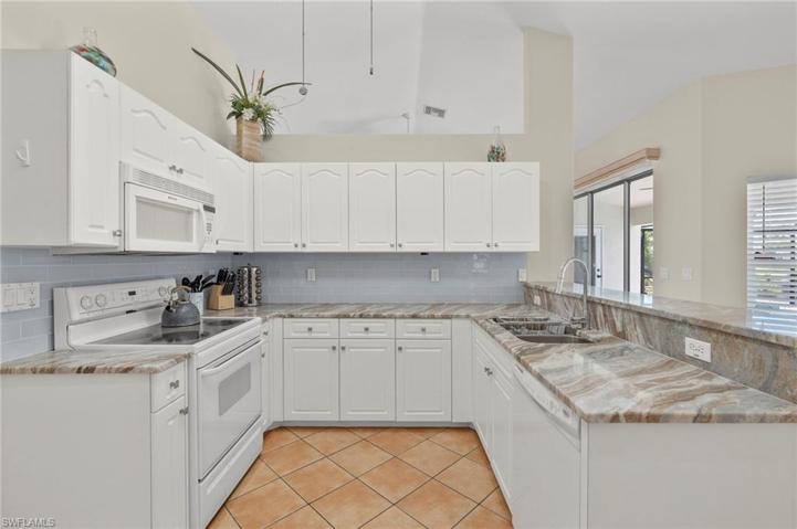 Updated Kitchen with vaulted ceiling, new granite tops & tiled back splash