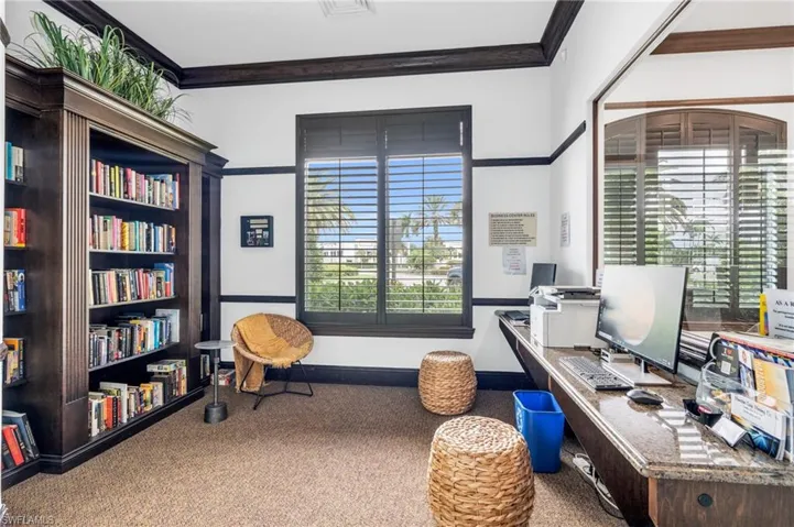 Carpeted home office with crown molding