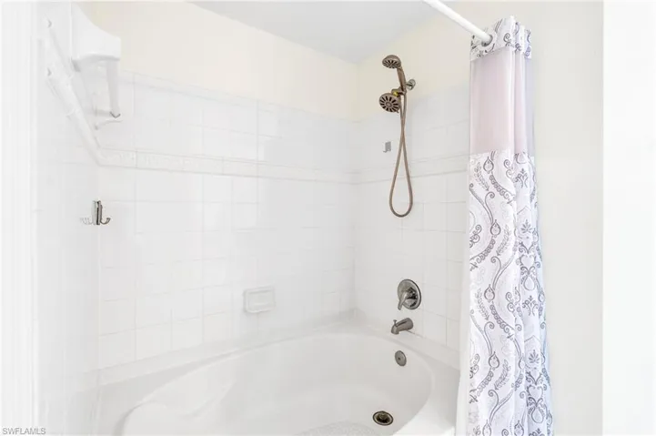 Bathroom featuring shower / bathtub combination with curtain