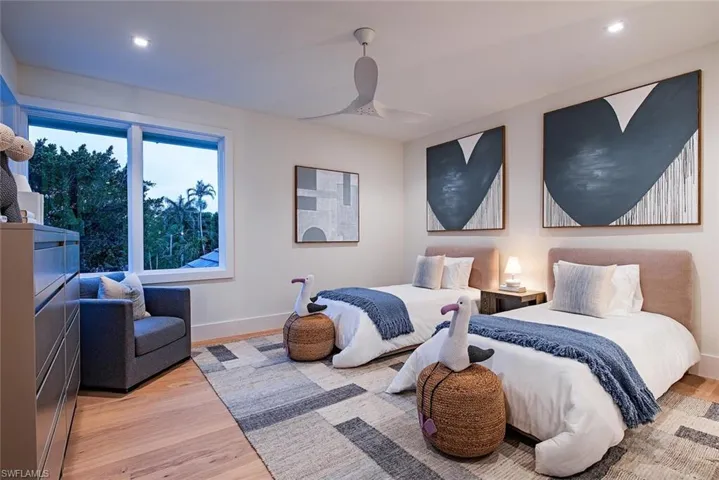 Bedroom with baseboards, a ceiling fan, wood finished floors, and recessed lighting